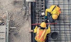 workmen pouring concrete